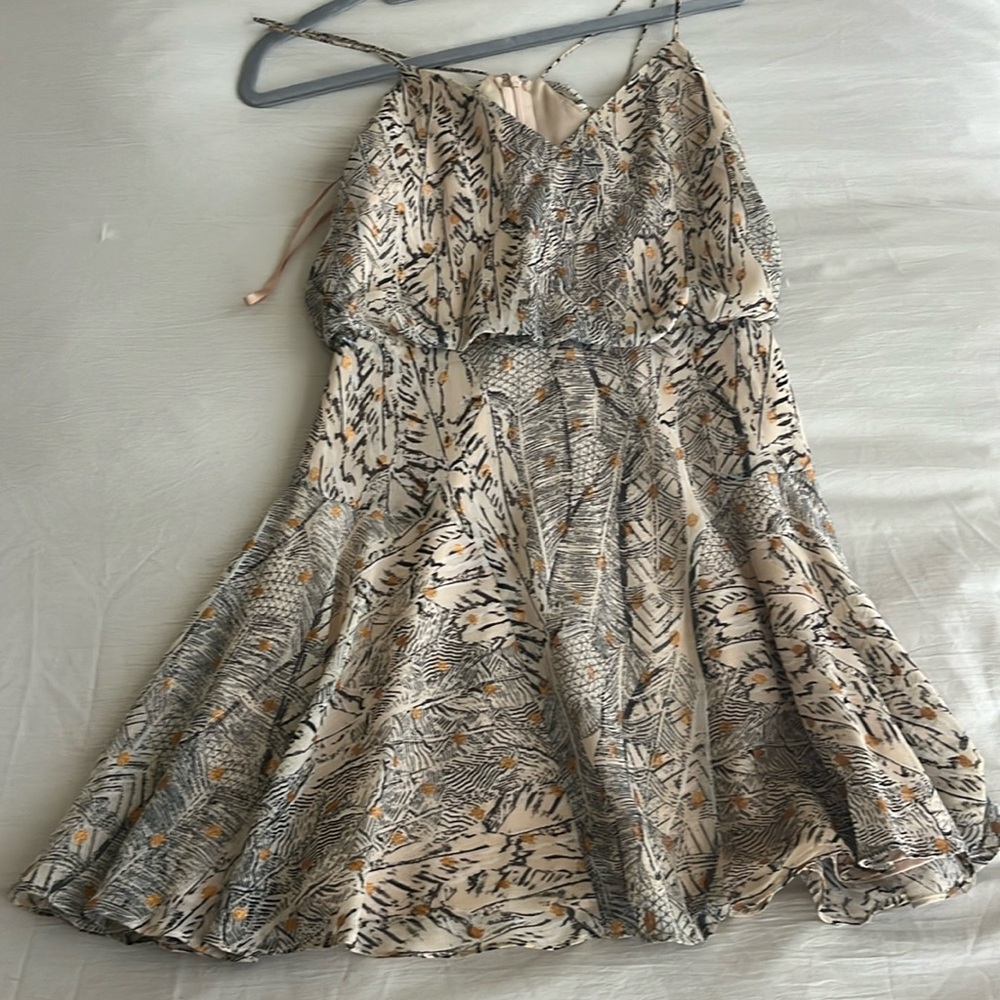 Tan dress with gold accents.